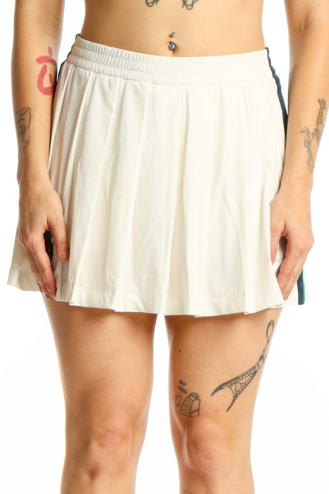 Cream pleated athletic skirt front view, TORY SPORT activewear XS with elastic waistband