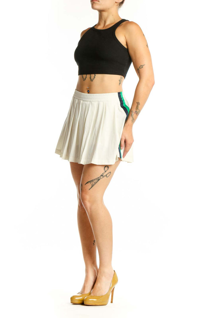 Cream pleated athletic skirt front view, TORY SPORT activewear XS with elastic waistband