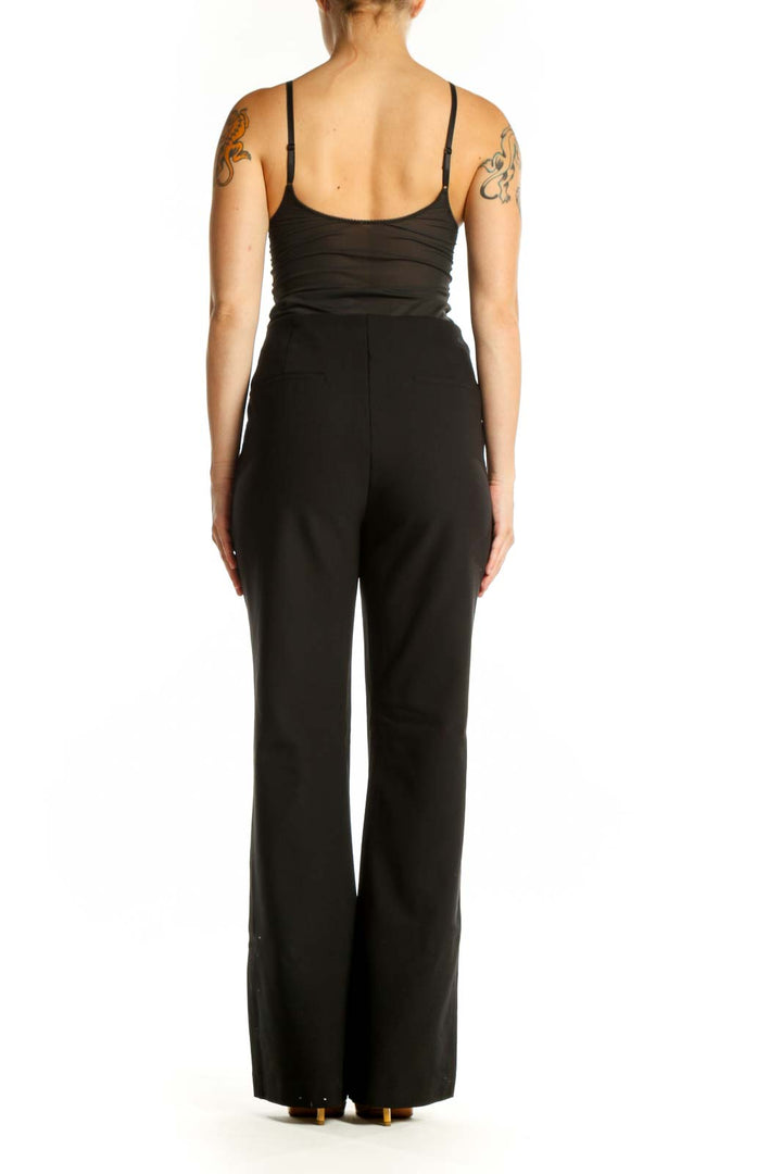 Black flare pants with high-waisted silhouette and stretchy fabric, back view