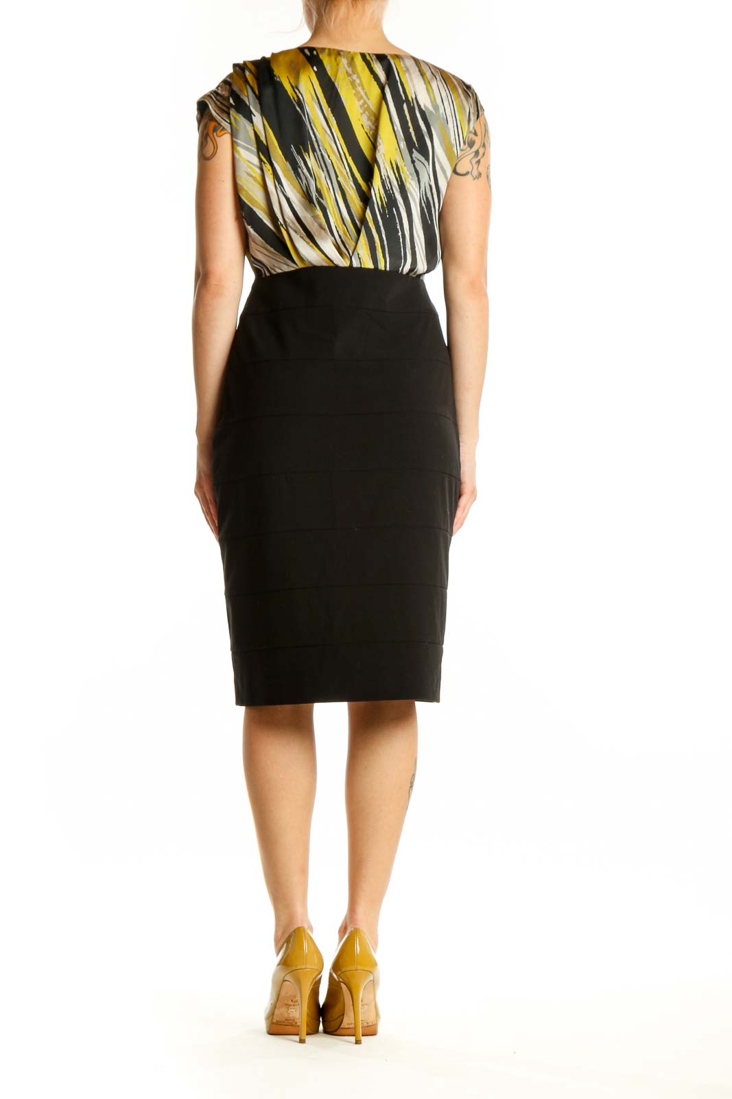 Black and gold striped wrap dress with black pencil skirt, back view on model