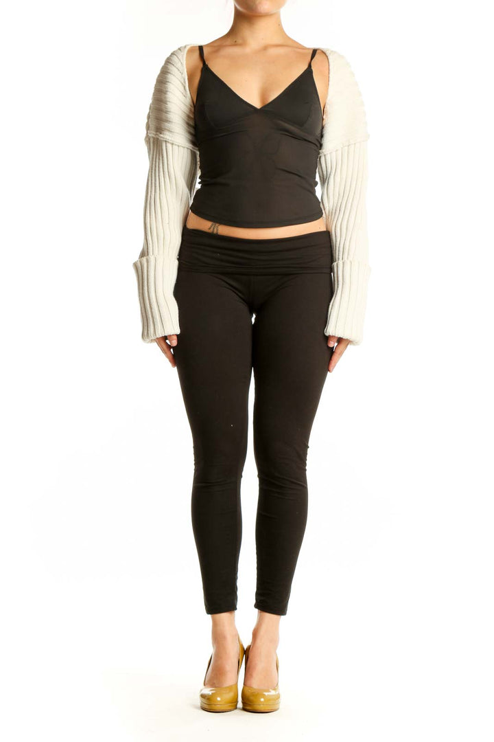 Black wrap crop top with cream ribbed knit sleeves, front view on model