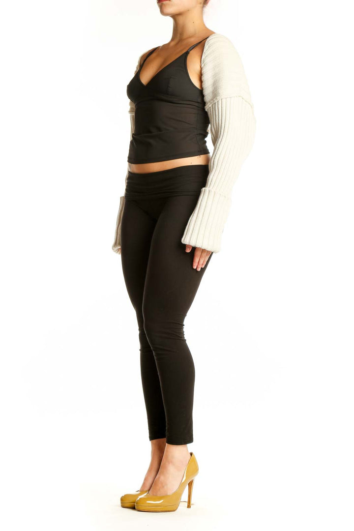 Black wrap crop top with cream ribbed knit sleeves, front view on model