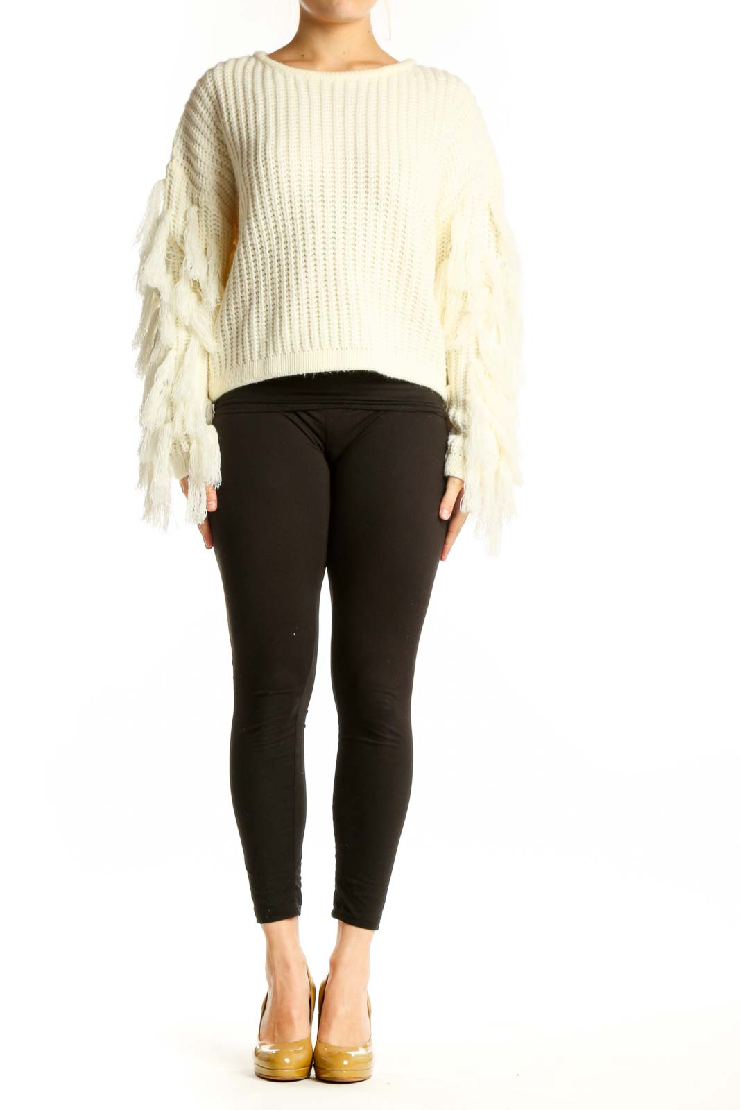Cream ribbed knit sweater with fringe-detailed sleeves, cropped length, worn with black pants