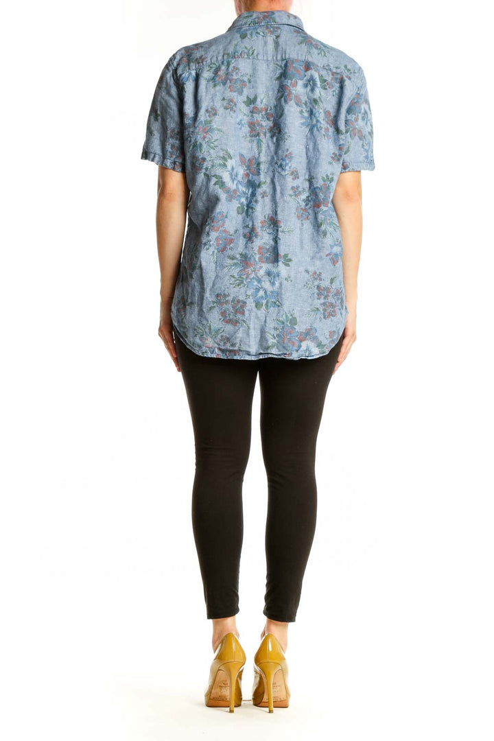 Blue floral button-up shirt with short sleeves and botanical print, back view