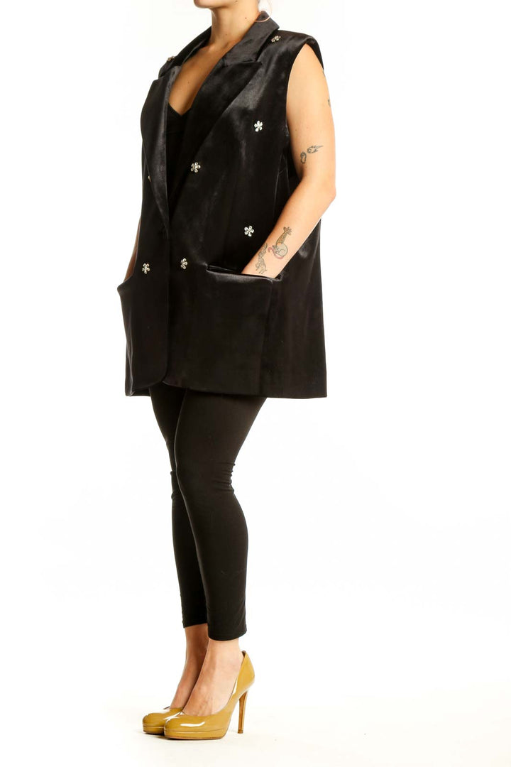 Black velvet blazer vest with silver snowflake embellishments, notched collar, and patch pockets, front view
