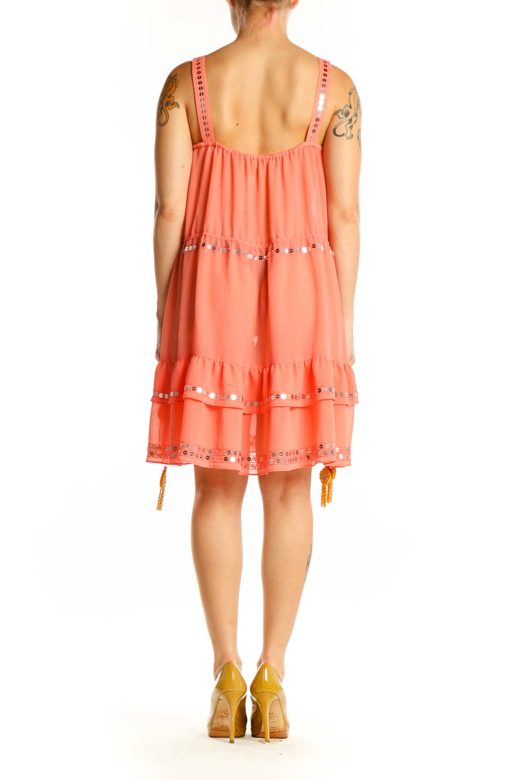 Coral tiered sleeveless dress with beaded trim and gold tassel details, back view