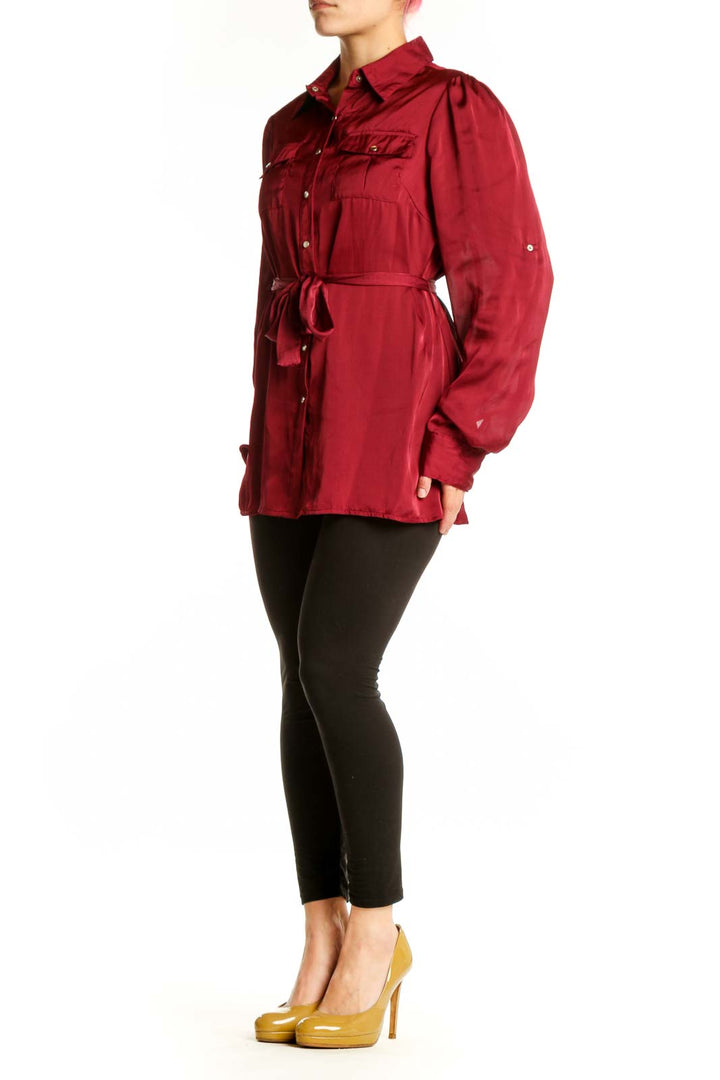 Burgundy button-up shirt with tie waist and chest pockets, front view