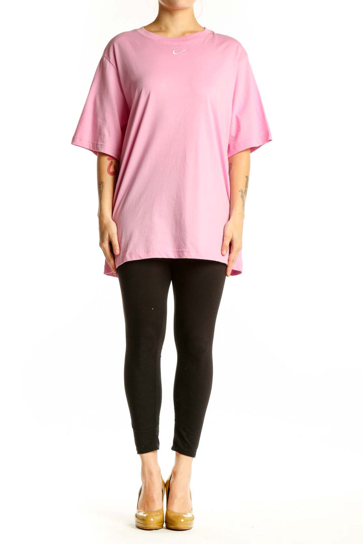 Pink cotton Nike oversized t-shirt with Swoosh logo, front view on model