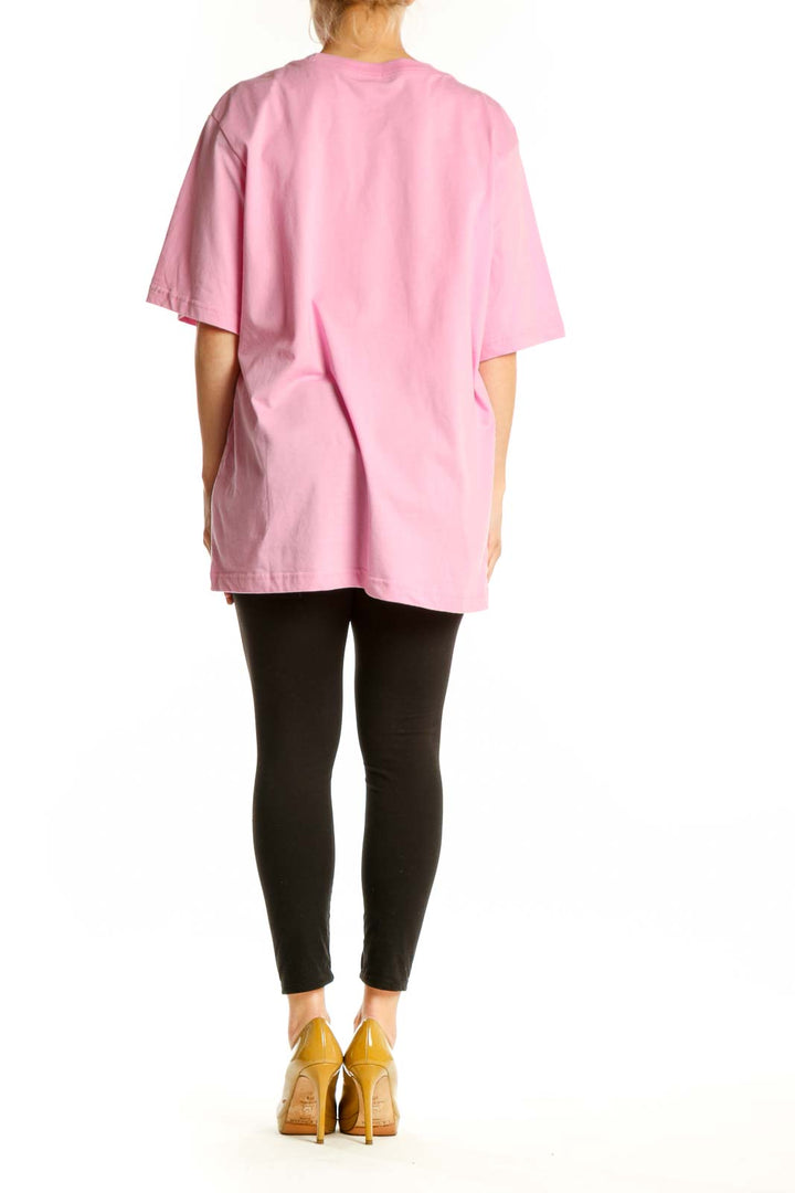 Pink cotton Nike oversized t-shirt back view, showing relaxed fit and length