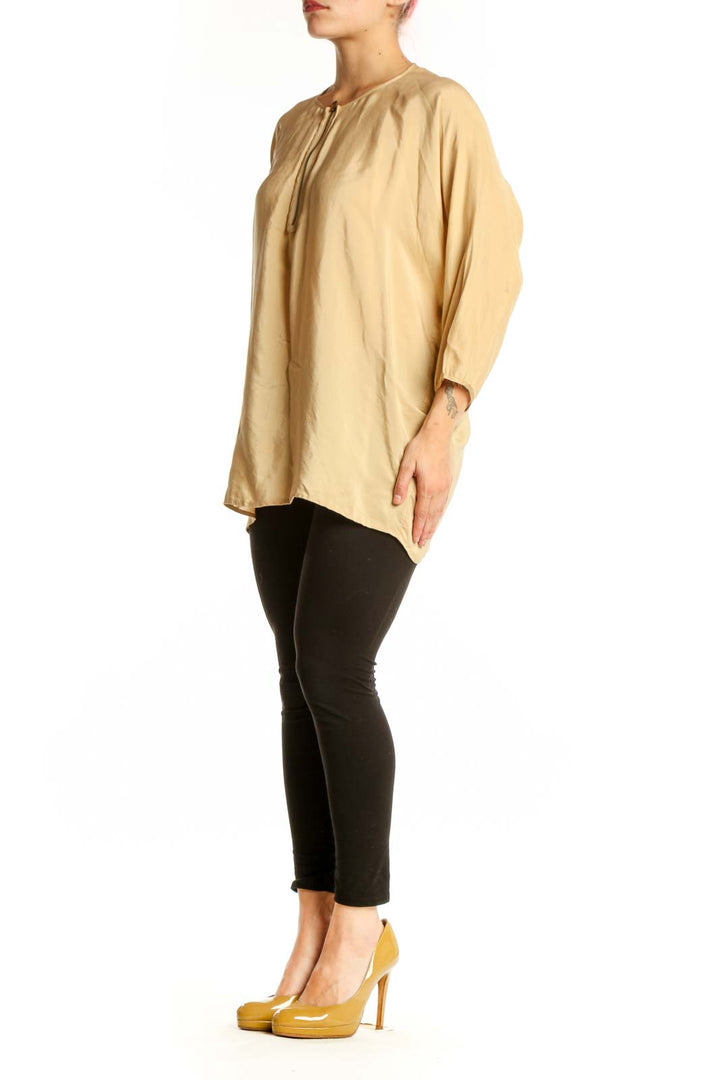 Cream silk tunic top with tie neckline and three-quarter sleeves, front view
