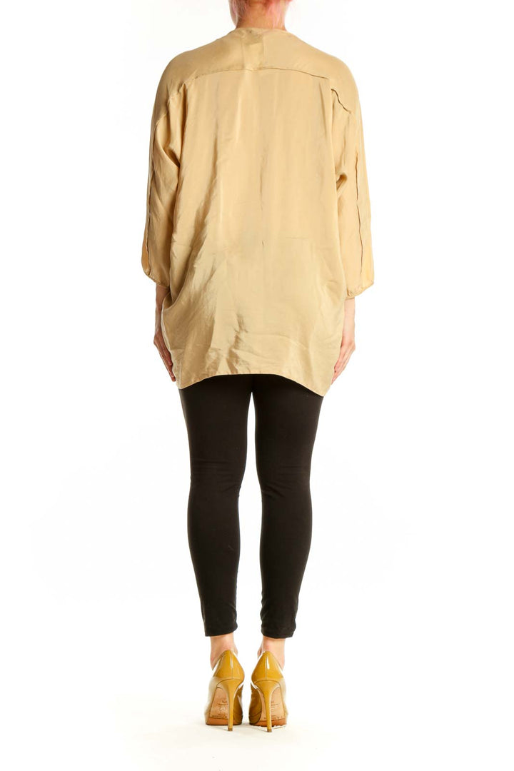 Cream silk tunic top with tie neckline, back view showing relaxed silhouette