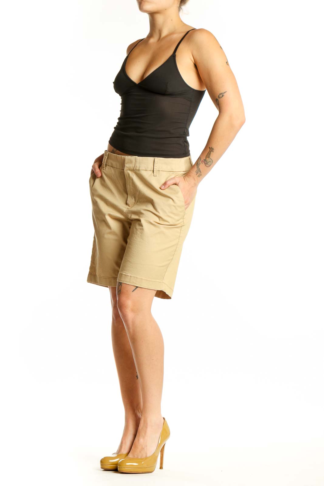 Front view of beige cotton Bermuda shorts with tailored fit and front pockets