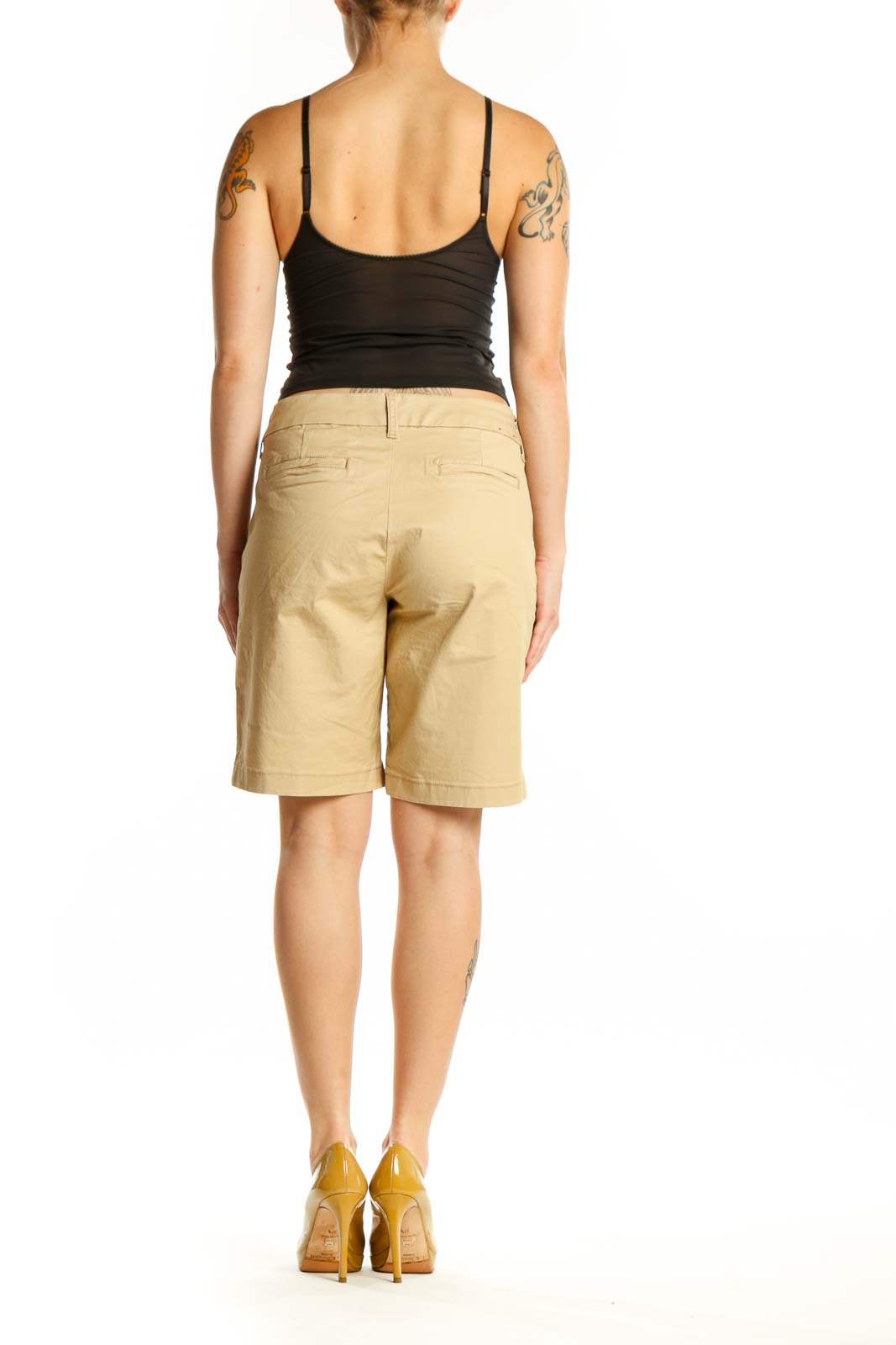 Back view of beige cotton Bermuda shorts showing rear pockets and knee-length cut