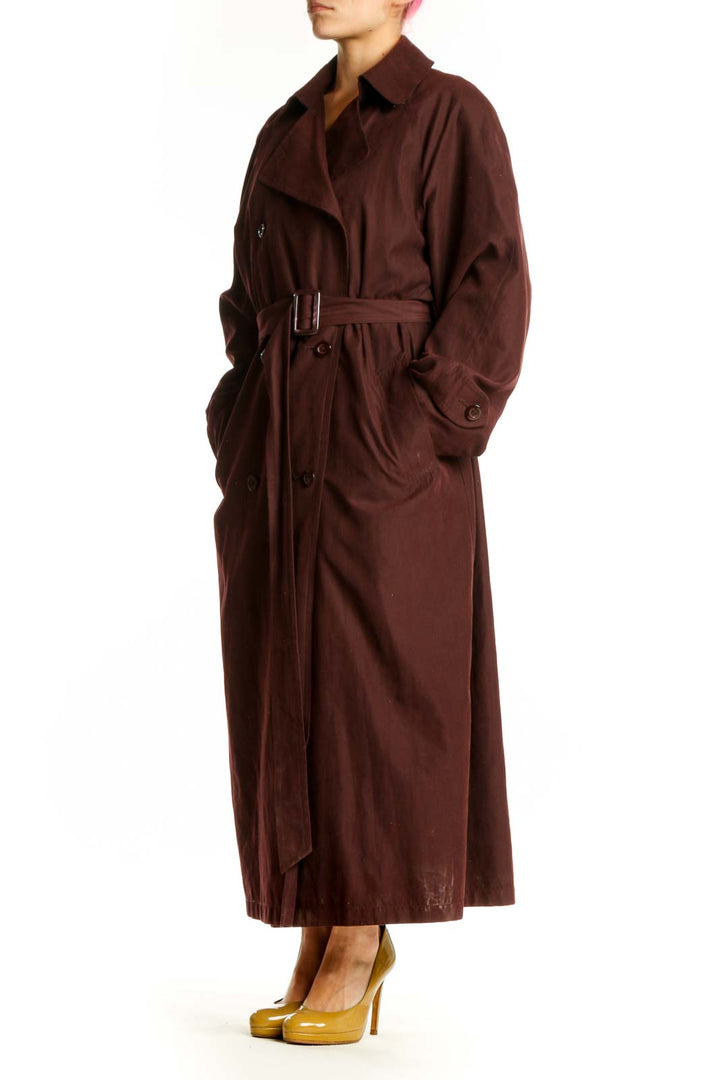 Burgundy double-breasted trench coat with adjustable belt and rolled cuffs, front view
