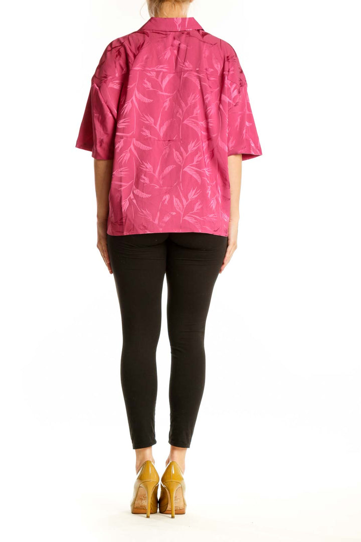 Pink floral ruffle button-up blouse back view showing relaxed fit and three-quarter length sleeves