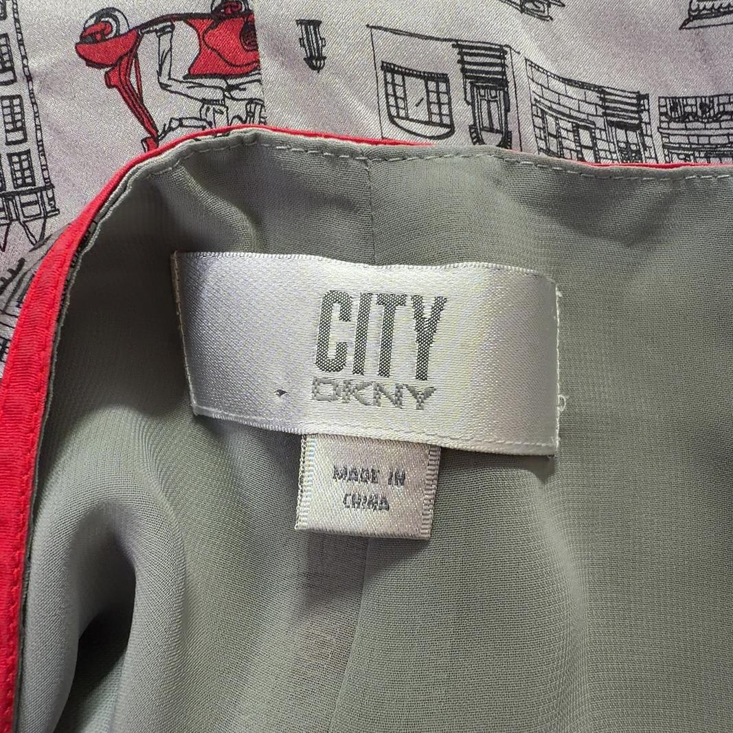 Tag view of cream architectural print DKNY midi skirt showing A-line silhouette and striped waistband detail