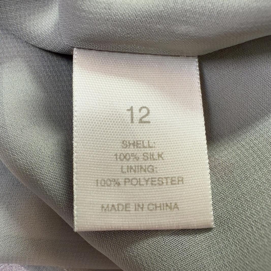 Tag view of cream architectural print DKNY midi skirt showing A-line silhouette and striped waistband detail