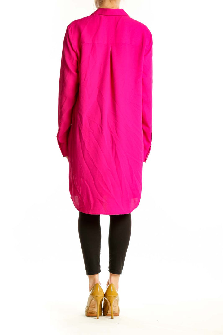 Back view of pink button-front shirt dress showing high-low hemline and relaxed silhouette