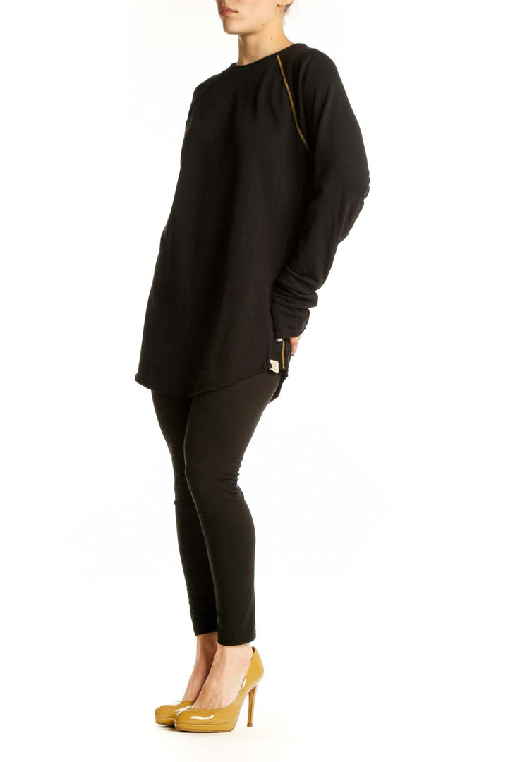 Black long sleeve tunic dress with gold piping detail and thumbhole cuffs, front view