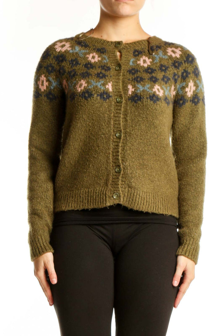 Olive green Fair Isle cardigan with cream and navy patterned yoke, button-front closure, worn with black pants