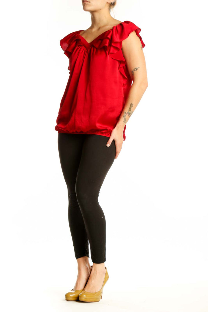 Red ruffle off-shoulder blouse with dramatic cap sleeves and gathered waist, front view