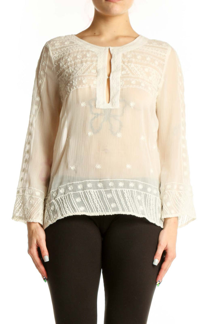 Cream embroidered Mango blouse with keyhole neckline and bell sleeves, front view on model