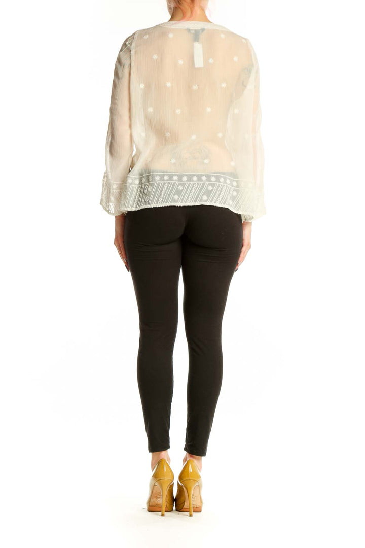 Cream embroidered Mango blouse with geometric patterned hem, back view on model
