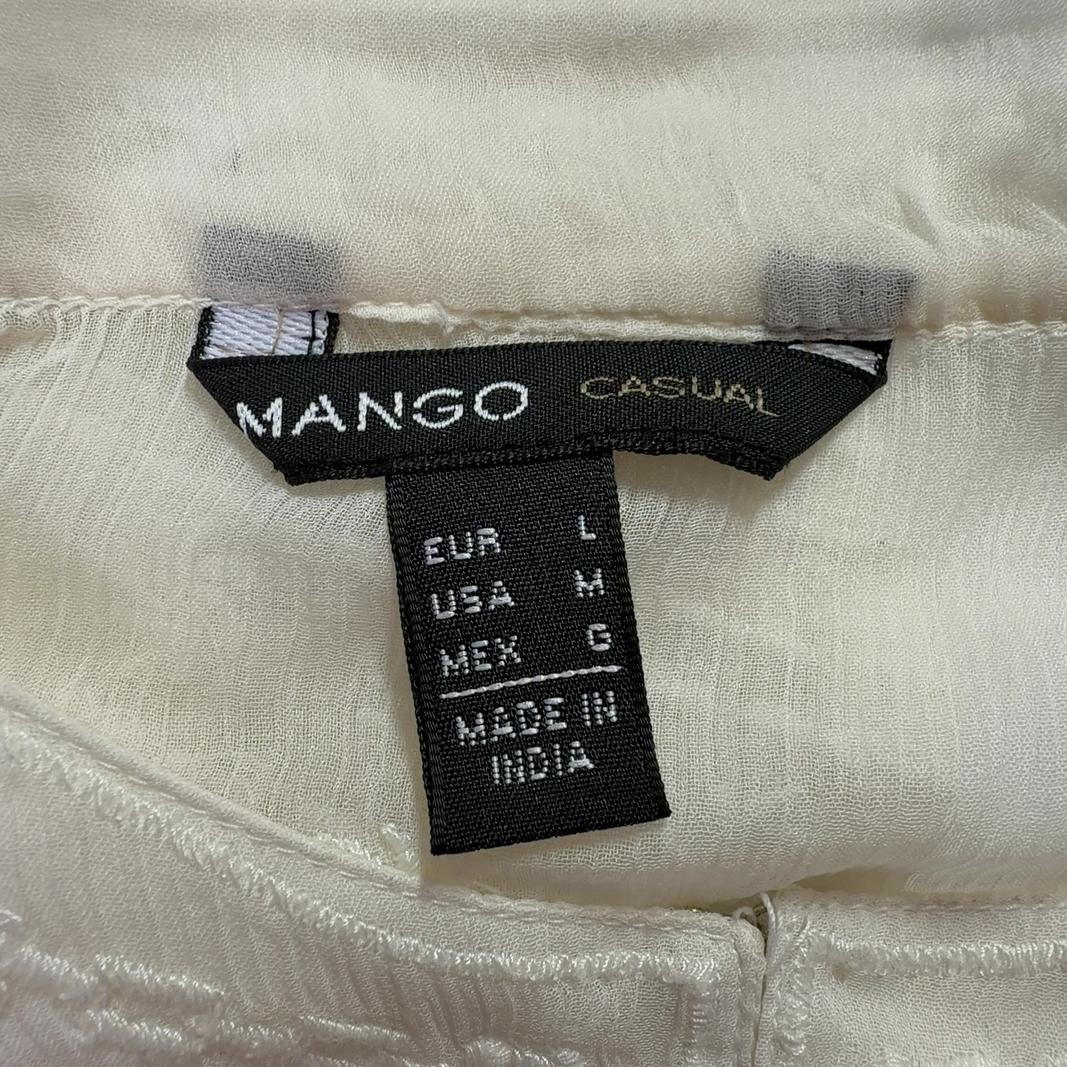 Cream embroidered Mango blouse with geometric patterned hem, back view on model