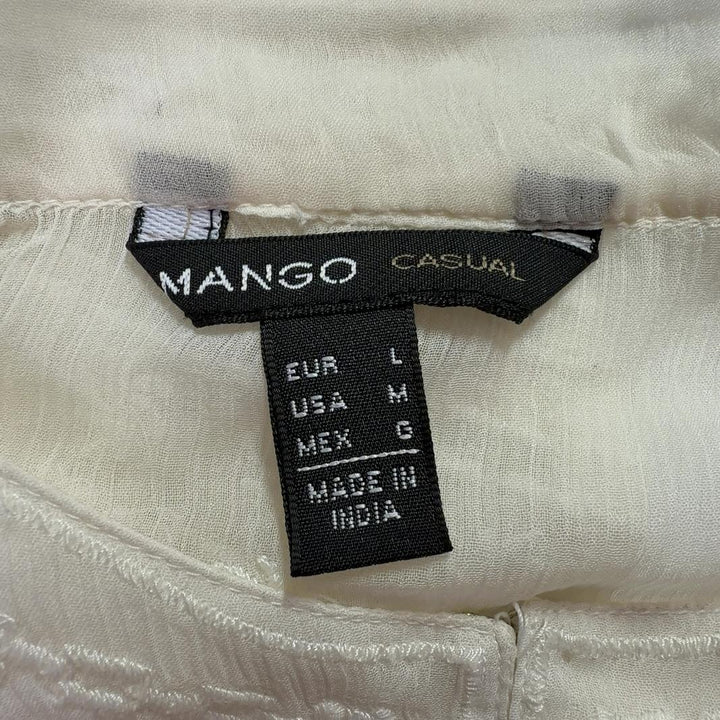 Cream embroidered Mango blouse with geometric patterned hem, back view on model