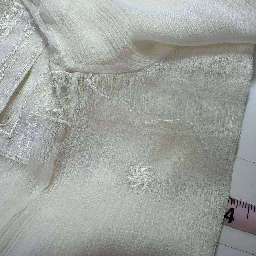 Cream embroidered Mango blouse with geometric patterned hem, back view on model