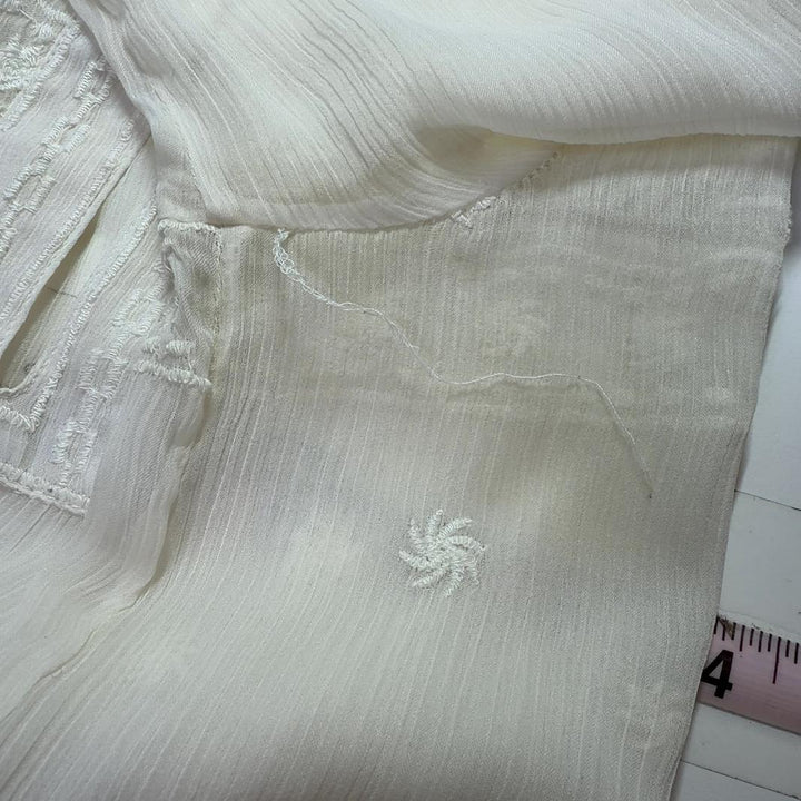 Cream embroidered Mango blouse with geometric patterned hem, back view on model