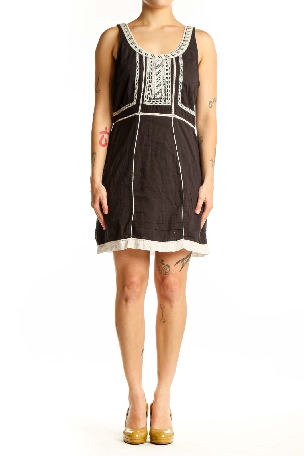 Black cotton Free People dress with white embroidered neckline and geometric chest detailing, front view