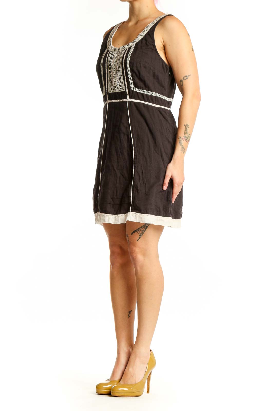 Black cotton Free People dress with white embroidered neckline and geometric chest detailing, front view