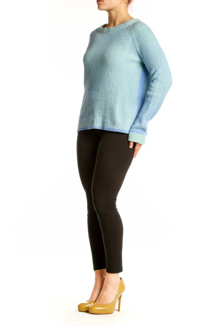 Front view of blue ribbed knit pullover sweater with crew neckline and contrast green and coral ribbed cuffs