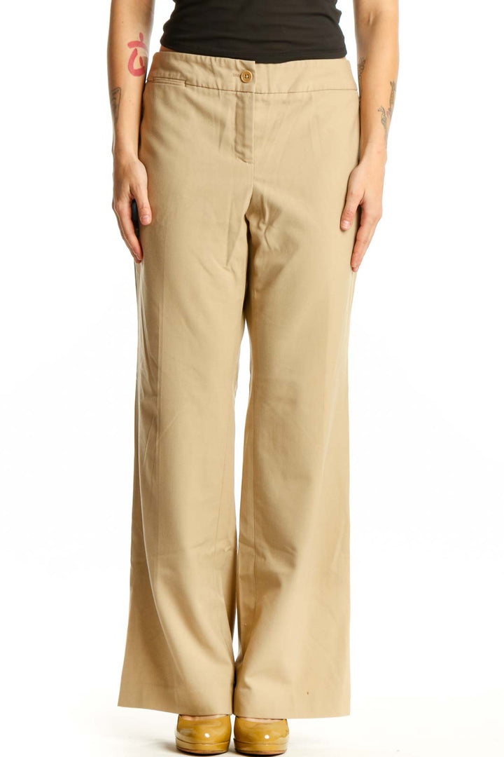 Beige wide-leg pants front view, showing classic button-front closure and relaxed fit