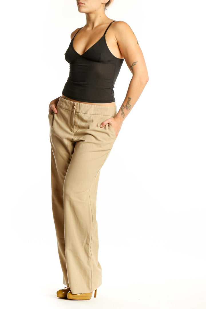 Beige wide-leg pants front view, showing classic button-front closure and relaxed fit