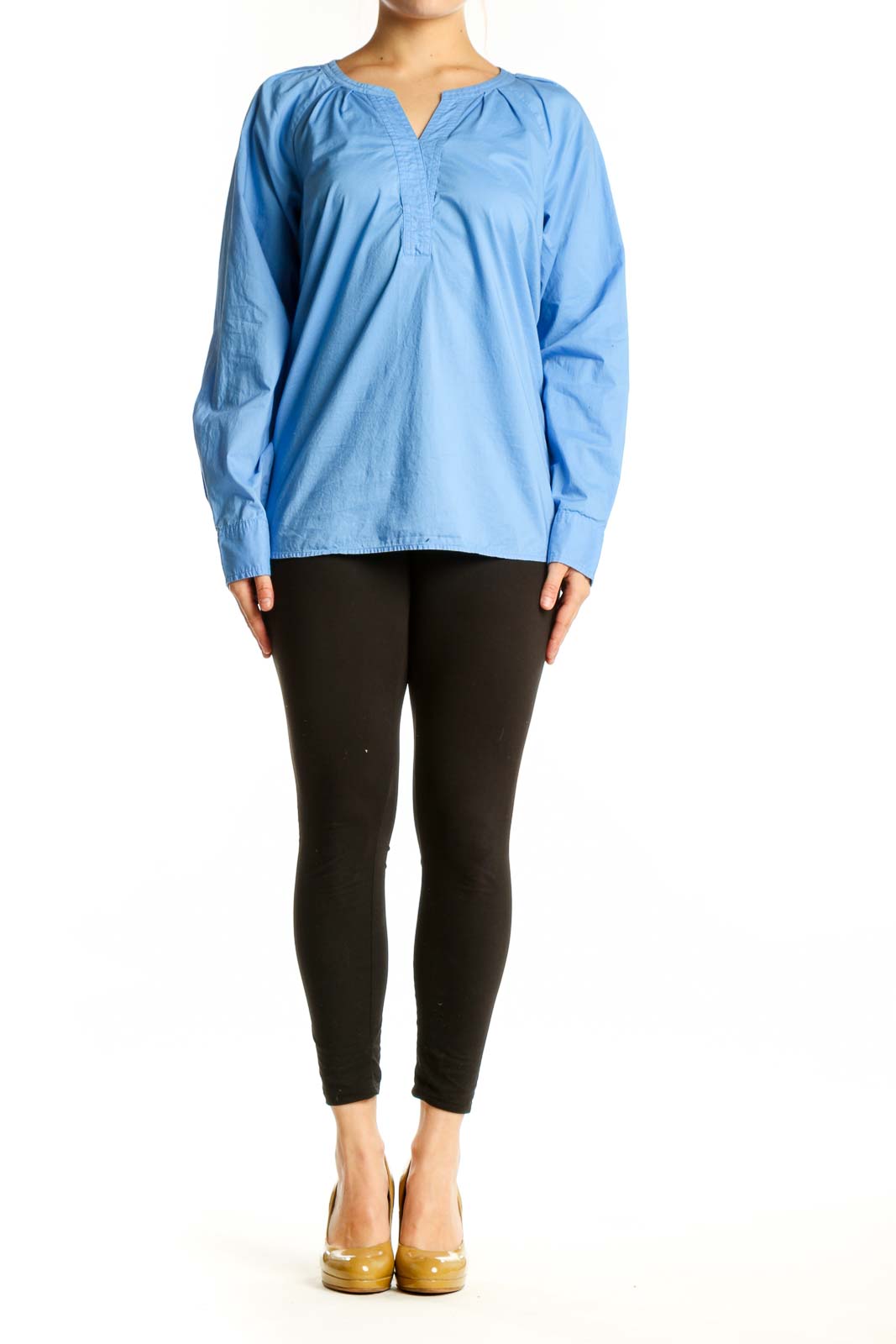 Blue cotton long sleeve henley top with gathered neckline, front view on model