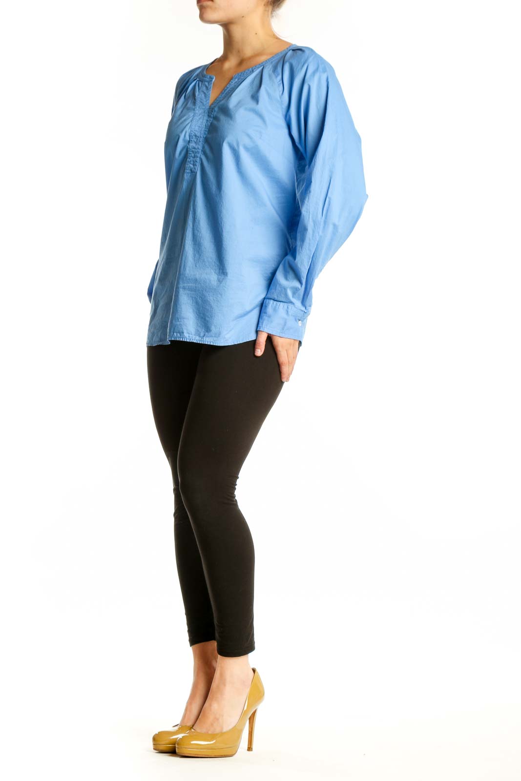 Blue cotton long sleeve henley top with gathered neckline, front view on model