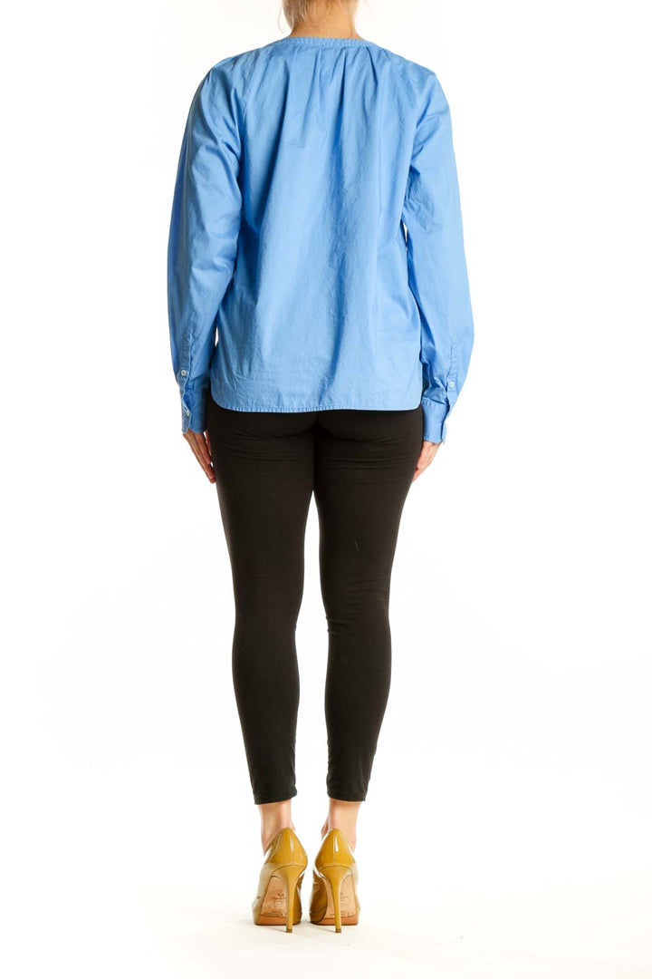 Blue cotton long sleeve henley top, back view showing relaxed fit and sleeve detail