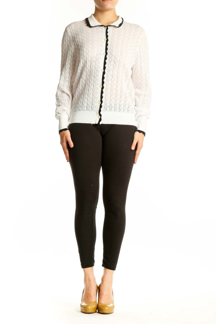 Cream cable knit cardigan with black contrast trim and Peter Pan collar, front view