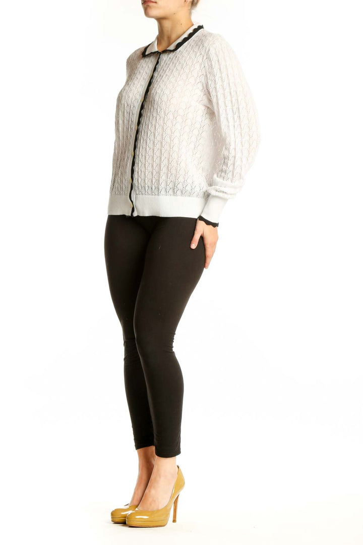 Cream cable knit cardigan with black contrast trim and Peter Pan collar, front view