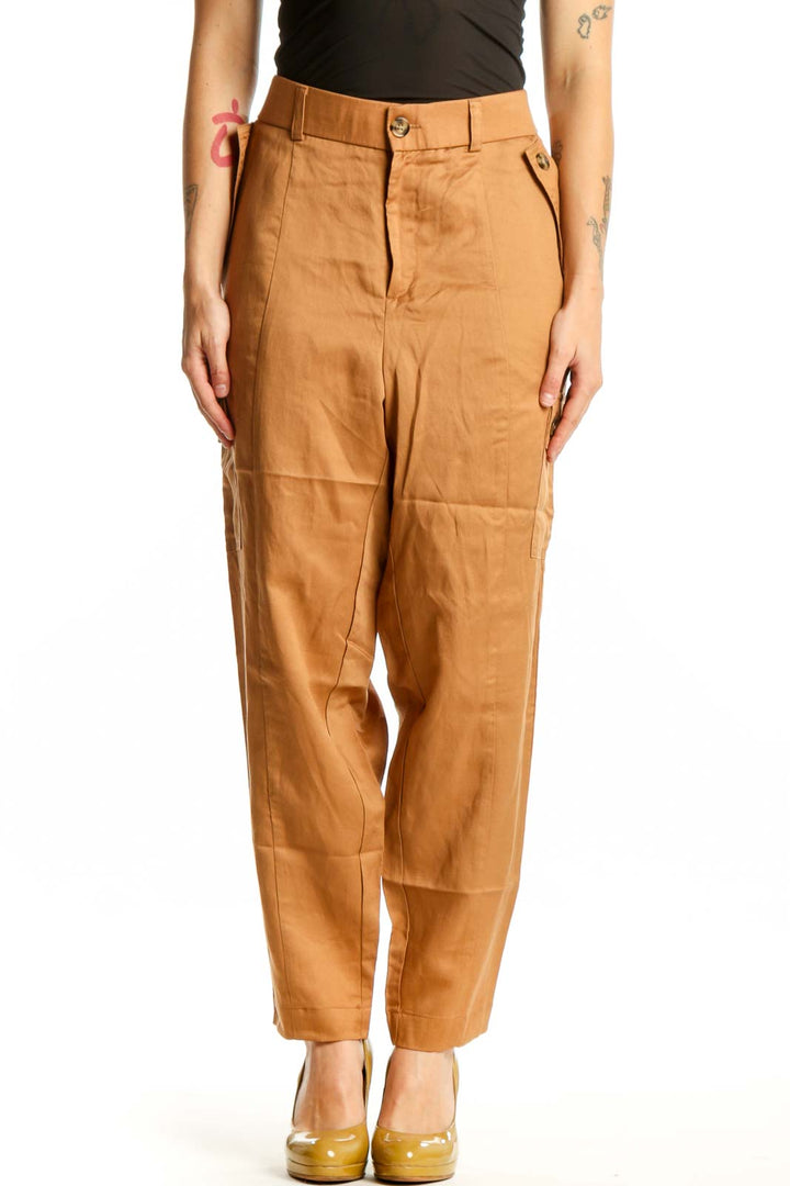 Front view of camel linen cargo pants with functional side pockets and high-waisted silhouette