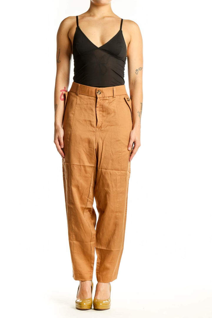 Front view of camel linen cargo pants with functional side pockets and high-waisted silhouette