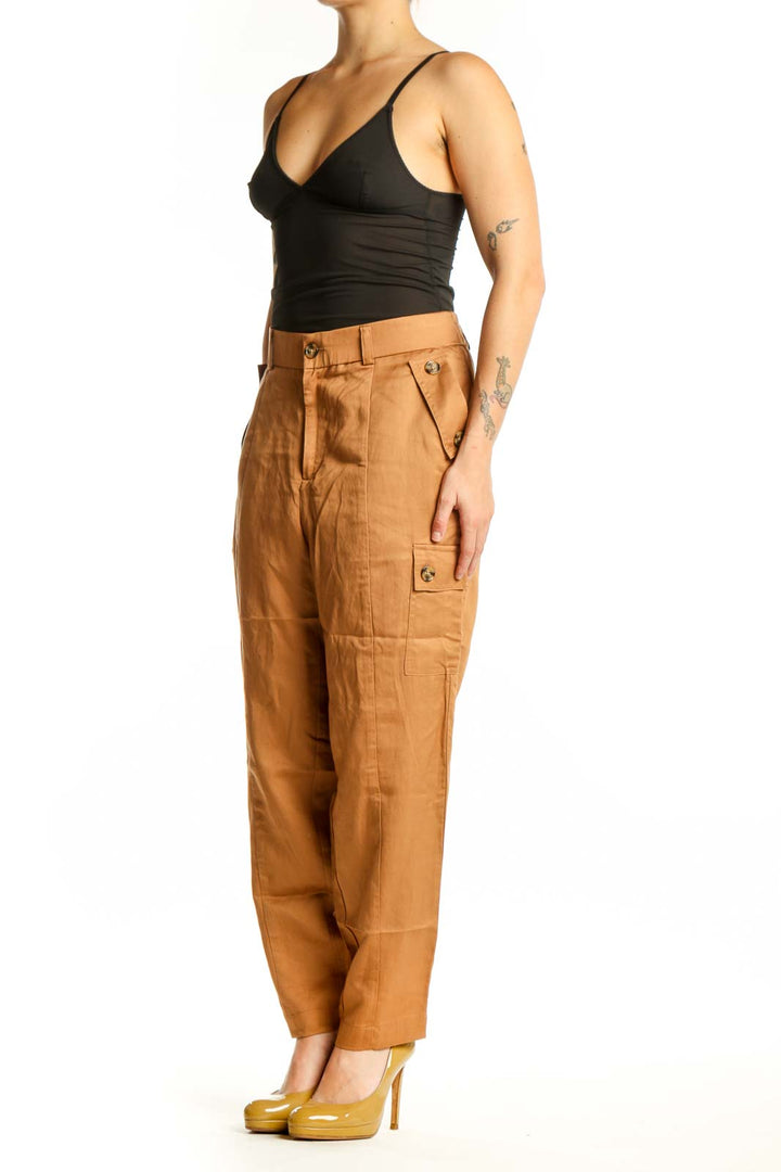 Front view of camel linen cargo pants with functional side pockets and high-waisted silhouette
