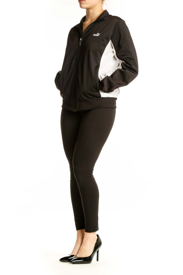 Black Puma Track Jacket with white contrast panels, full-length zip closure, and ribbed collar on model