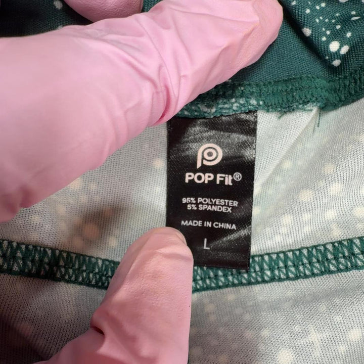 Tag view of teal geometric sparkle activewear leggings by Pop Fit, size L, showing flattering fit and geometric pattern detail