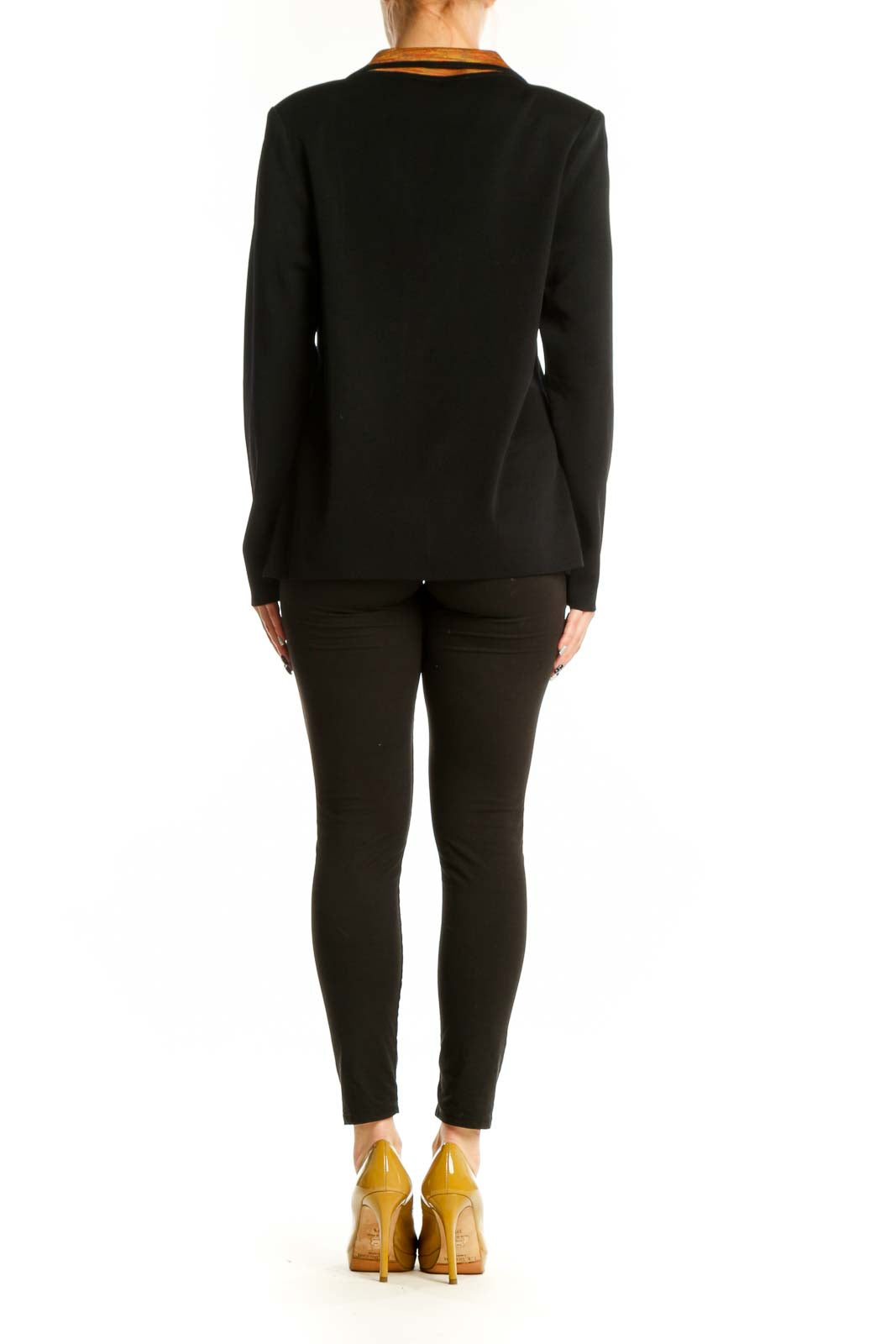 Back view of black cardigan with orange trim detail, showing structured silhouette and long sleeves