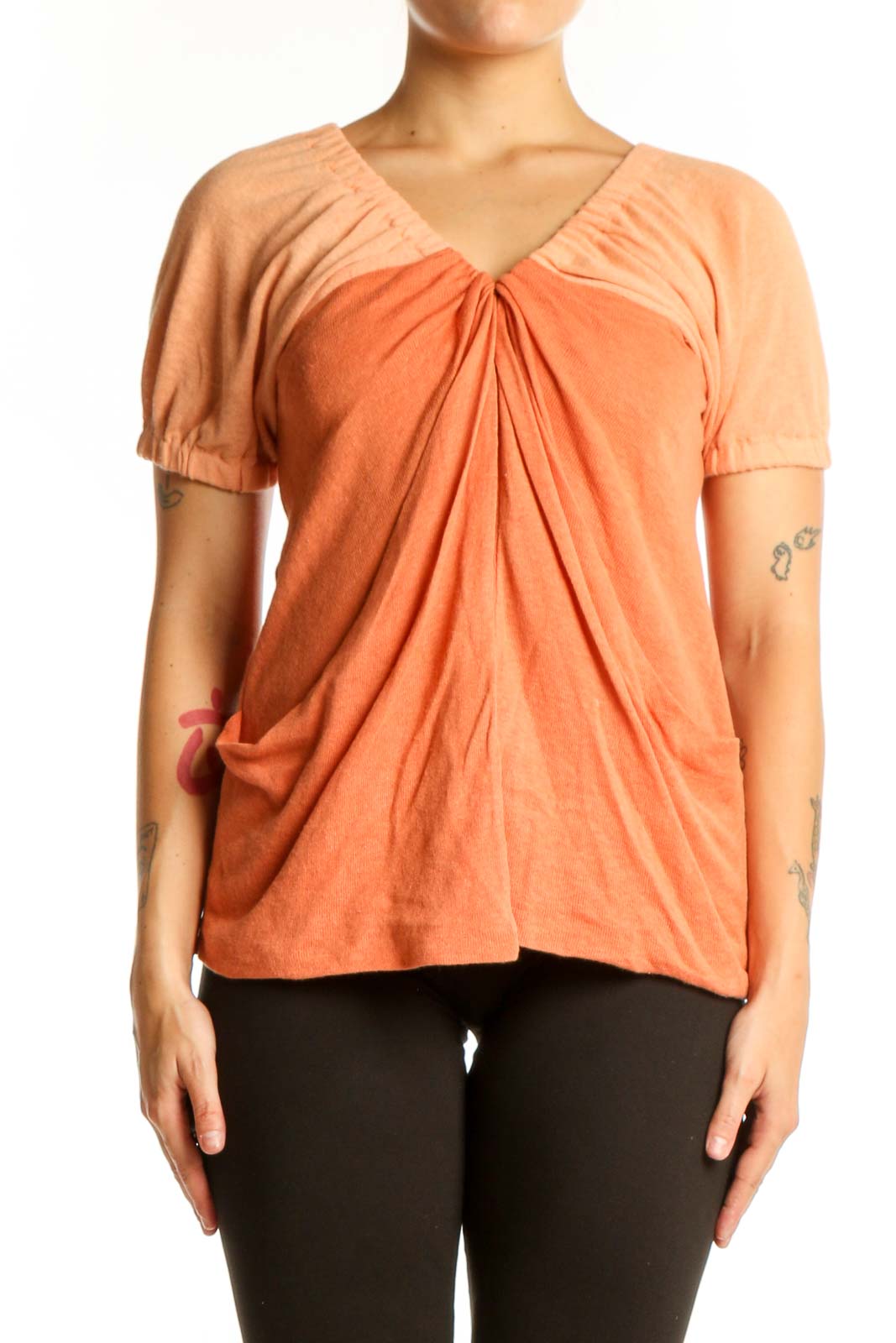 Free People orange ruched cotton-linen top with V-neckline and puffed sleeves, front view on model