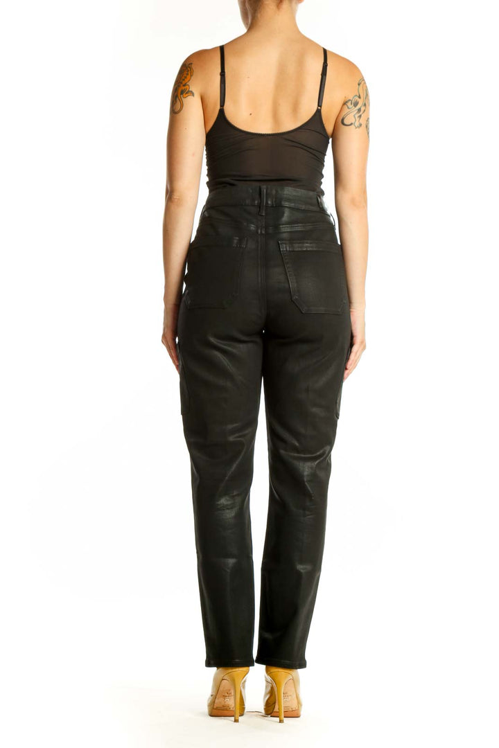 Black cargo denim pants by Paige showing back pockets and cargo details, side view