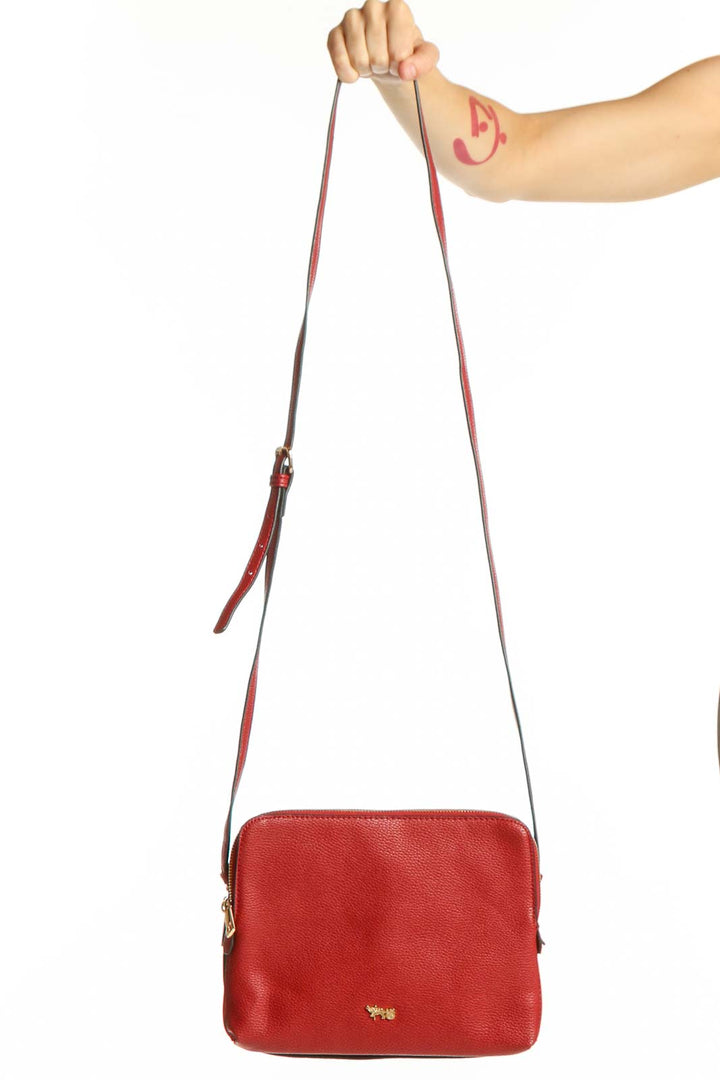 Red leather crossbody bag by Mathew+Julian with adjustable strap and gold hardware, front view